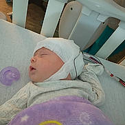 Oakley joined the competition — help win amazing prizes! baby, sleeping, crib, blanket, pacifier, medical_wires, cap, infant, bed, resting, child, peaceful, indoors, person, healthcare, soft, cozy, cute, newborn, quiet