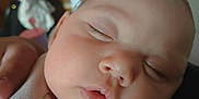 Kingsley joined the competition — help win amazing prizes! baby, blurred_background, chubby_cheeks, close_up, clothing, eyelashes, face, hand, indoors, infant, mouth, newborn, nose, peaceful, person, portrait, resting, skin, sleeping, soft_light