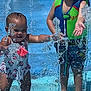 Syrenity joined the competition — help win amazing prizes! toddler, baby, water_splash, swimsuit, life_vest, water_jet, outdoor, summer, play, child, fun, splash_pad, happy, water_droplets, barefoot, sunlight, joy, pool_area, blue_surface, swimming
