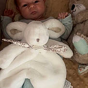 Ilyan participe au concours pour gagner de l'argent avec cette photo : baby, infant, plush_toy, blanket, soft_texture, stuffed_animal, cute, sleepwear, child, comfort, lying_down, indoors, toy, peaceful, face, hand, footwear, nursery, cuddle, rest