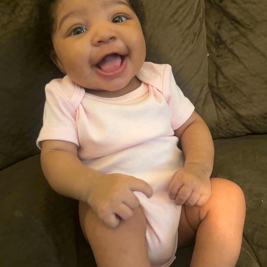 Aliysn is registered to the contest to win money with this photo: ankle, baby, babylaughing, bodypart, couch, cushion, face, finger, furniture, hand, happy, head, homedecor, laughing, newborn, person, photography, portrait, sitting, smile