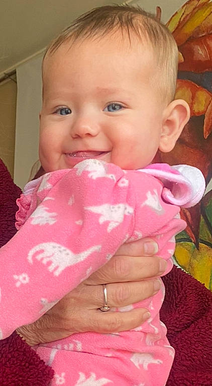 Raquel is registered to the contest to win money with this photo: baby, baby_toddler_clothing, cheek, eyelash, finger, gesture, hand, happy, iris, joy, lip, mouth, nail, neck, nose, person, pink, product, skin, sleeve