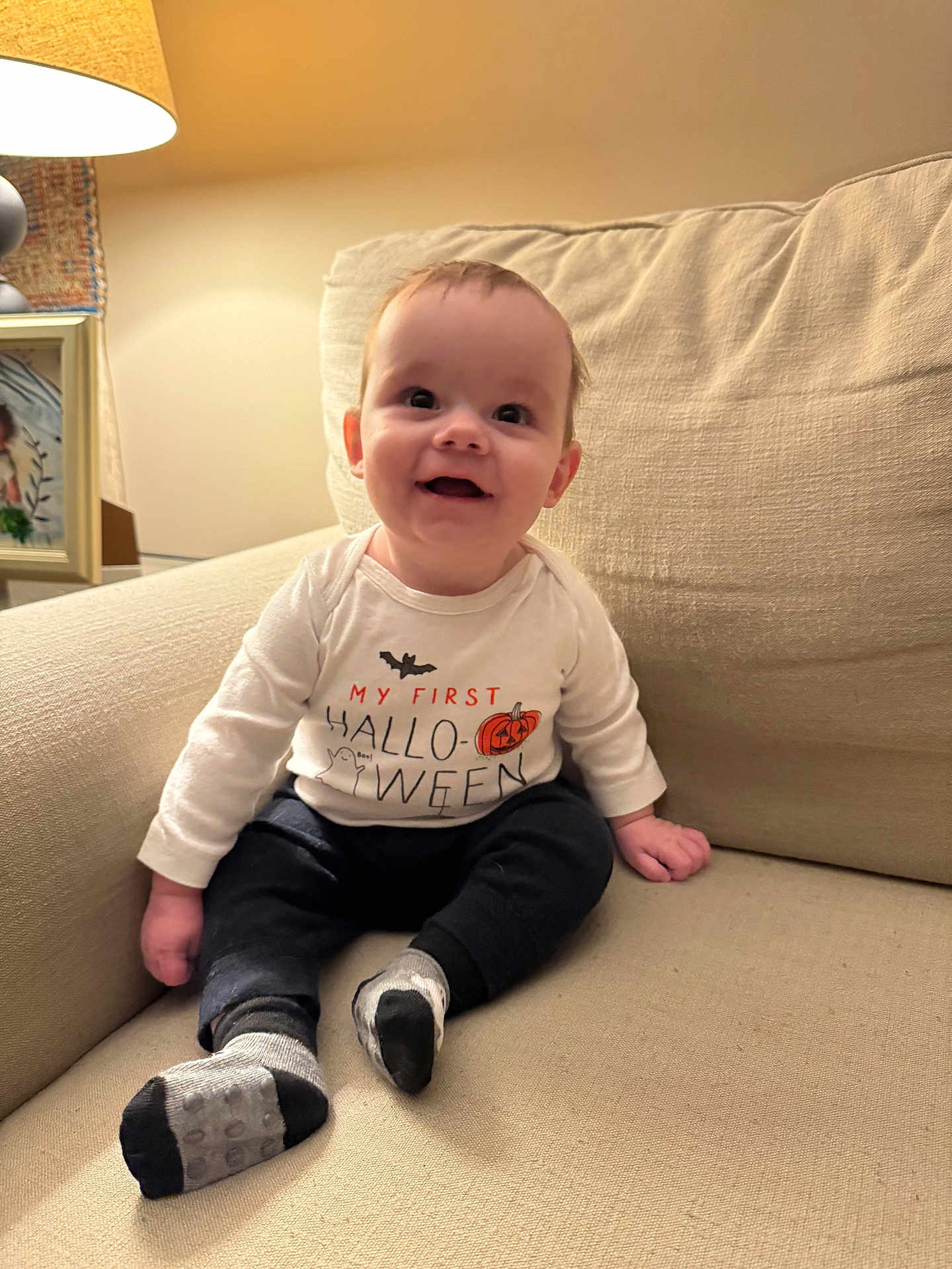 Cooper joined the competition — help win amazing prizes! baby, child, smiling, indoors, couch, lamp, halloween, shirt, socks, happy, portrait, infant, home, cozy, seated, cute, celebration, decor, person, young