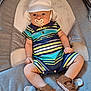 Leo is registered to the contest to win money with this photo: baby, infant, child, pacifier, hat, striped_clothing, romper, sandals, seated, gray_seat, cute, chubby_cheeks, curious_eyes, indoor, comfortable, casual_clothing, footwear, baby_accessory, soft_lighting, portrait