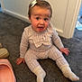 Ivy joined the competition — help win amazing prizes! baby, child, sitting, smiling, happy, indoors, carpet, knitwear, socks, bow, hair_accessory, footwear, pink_slippers, expression, person, cute, young_child, floor, cozy, casual