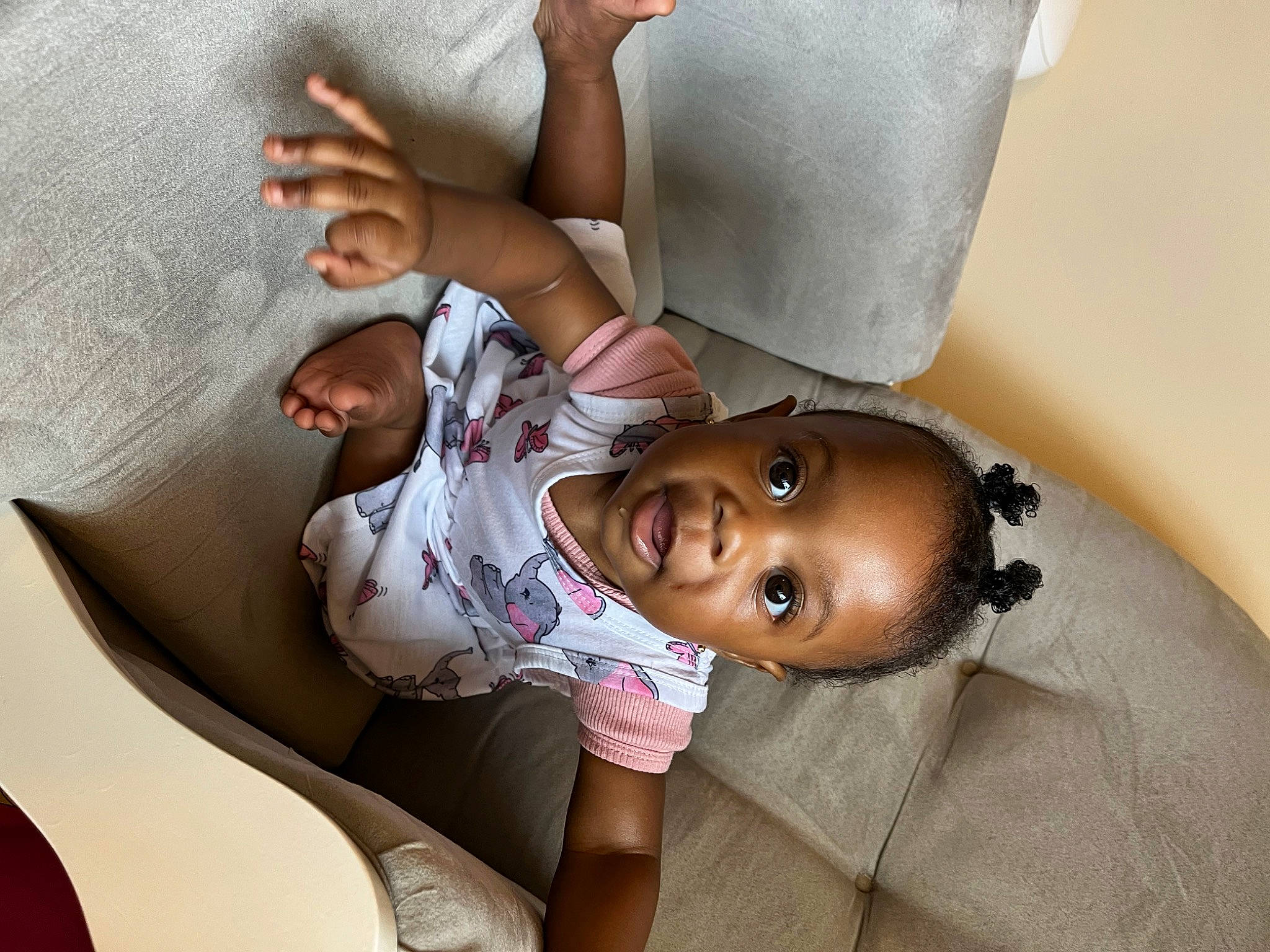 Melanie joined the competition — help win amazing prizes! baby, baby_toddler_clothing, child, comfort, couch, elbow, finger, happy, hat, human_body, human_leg, knee, leg, linens, mouth, person, sitting, skin, smile, thigh