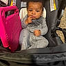 Drayce joined the competition — help win amazing prizes! baby, child, toddler, stroller, seated, portrait, face, smiling, thoughtful, indoor, gray_outfit, pink_bag, car_seat, shopping_bag, curly_hair, dark_skin, finger_to_lips, cozy, candid, photography