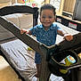 Jaxon joined the competition — help win amazing prizes! toddler, child, playpen, smile, indoor, blue_clothing, toy, carpet, window, recliner, living_room, curly_hair, happy, baby, furniture, person, daylight, home, standing, grip