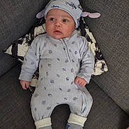 Joshua a rejoint le concours — aidez-le/la à gagner de superbes lots ! baby, infant, couch, pillow, hat, onesie, socks, striped_socks, baby_clothes, face, eyes, hands, laying, living_room, home_interior, fabric, soft, cozy, portrait, cute