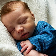 Hudson joined the competition — help win amazing prizes! baby, newborn, sleeping, blanket, cozy, blue_sweater, hand, face, close_up, portrait, peaceful, soft_texture, fleece, infant, eyelids, nap, mouth, skin, bedding, comfort