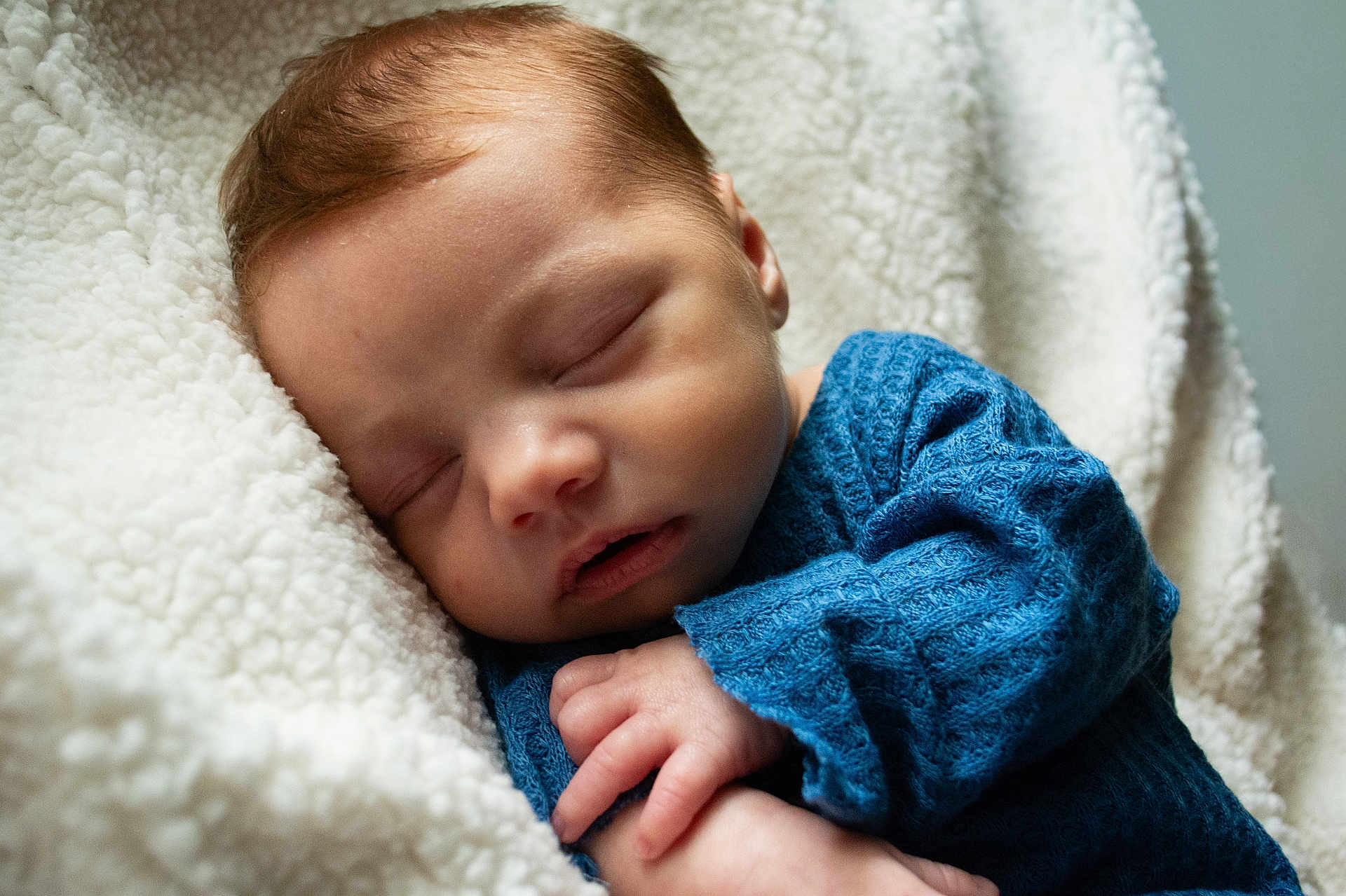 Hudson joined the competition — help win amazing prizes! baby, newborn, sleeping, blanket, cozy, blue_sweater, hand, face, close_up, portrait, peaceful, soft_texture, fleece, infant, eyelids, nap, mouth, skin, bedding, comfort