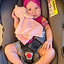 Ella participe au concours pour gagner de l'argent avec cette photo : baby, car_seat, plush_toy, headband, pacifier, pink, maroon, infant, child, sitting, safety_harness, indoor, cute, soft_toy, warning_label, airbag, clothing, person, legs, hand
