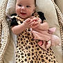 Ella participe au concours pour gagner de l'argent avec cette photo : baby, baby_girl, basket, child, clothing, comfort, cushion, cute, face, hair_bows, hand, happy, indoors, infant, leopard_print, person, plush_toy, sleeping_basket, smiling, soft_toy