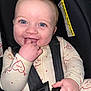 baby, infant, smiling, blue_eyes, car_seat, seat_belt, onesie, hand_in_mouth, buckle, closeup, portrait, rosy_cheeks, happy, cute, child, human_face, fabric, warning_label, sitting, finger
