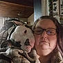 Helena is registered to the contest to win money with this photo: woman, dog, indoor, blanket, glasses, plaid, cozy, snuggle, pet, face, portrait, affection, bond, warm, casual, adult, head, comfort, relaxed, expression