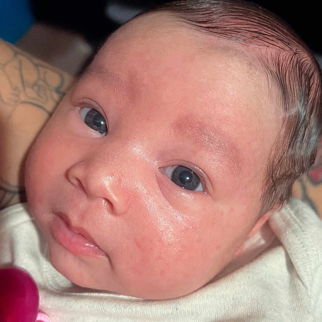 Emeri is registered to the contest to win money with this photo: accessories, baby, bodypart, clothing, cutlery, ear, face, finger, hand, head, mouth, newborn, person, photography, portrait, selfie, skin, spoon, t_shirt, tattoo