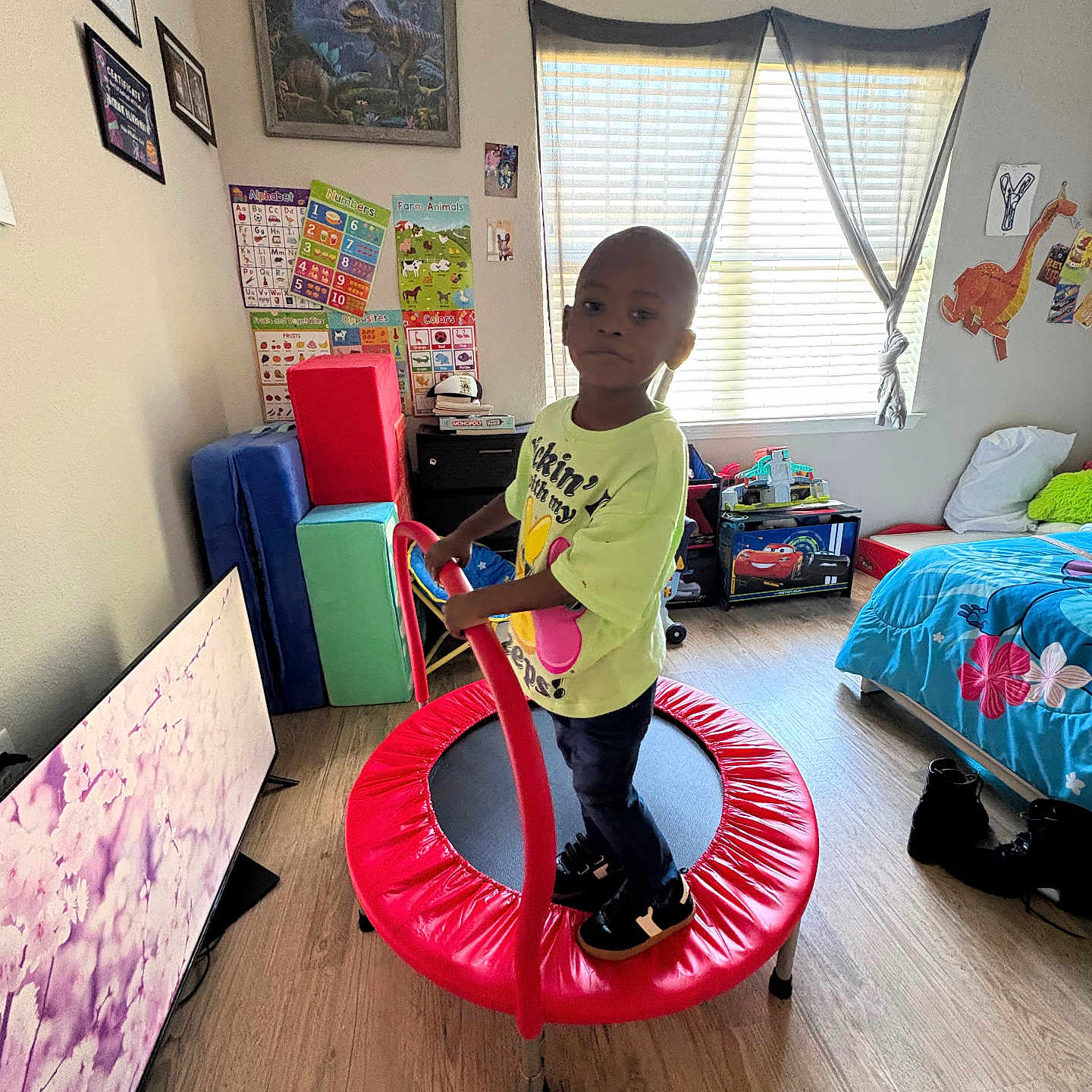 Antoine joined the competition — help win amazing prizes! bed, bedroom, child, clothing, colorful, education, floor, flooring, furniture, indoor, light, person, play, posters, shoes, toys, trampoline, wall, window, young