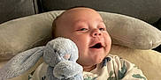Lenny joined the competition — help win amazing prizes! baby, bunny, child, clothing, comfort, couch, cozy, cute, hand, happy, indoor, infant, onesie, pillow, plush_toy, portrait, relaxing, smiling, soft_toy, window