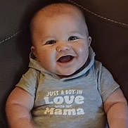 Jax is registered to the contest to win money with this photo: arms, baby, boy, casual_clothing, child, chubby_cheeks, closeup, comfortable, cute, face, happy, hoodie, indoor, infant, leather_couch, portrait, sitting, smiling, text_on_clothing, young_child