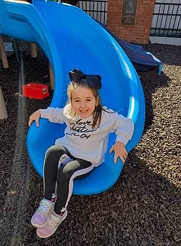 Ashlyn joined the competition — help win amazing prizes! aqua, baby_toddler_clothing, blue, child, chute, city, electric_blue, facial_expression, fun, happy, joy, leisure, outdoor_play_equipment, person, playground, playground_slide, public_space, recreation, sitting, smile