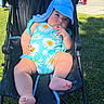 Gianna joined the competition — help win amazing prizes! baby, stroller, blue_hat, swimsuit, daisies, fingers, outdoor, grass, playground, sunny, child, infant, cute, relaxed, summer, park, foot, seat, shade, person