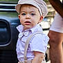 édouard participe au concours pour gagner de l'argent avec cette photo : toddler, child, boy, hat, bow_tie, suspenders, beige, white_shirt, outdoor, vehicle, person, blue_eyes, portrait, fashion, cute, curious, background_blur, adult, casual, summer