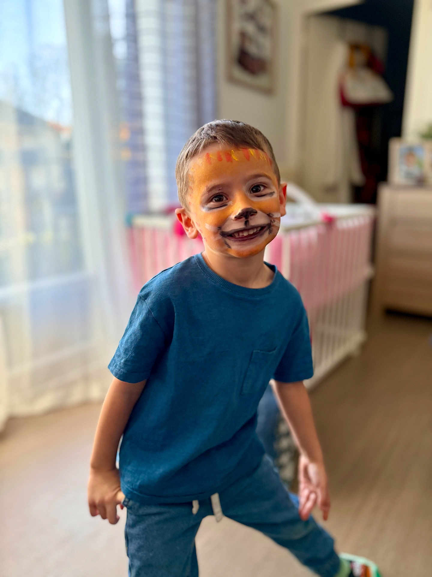 Marley a rejoint le concours — aidez-le/la à gagner de superbes lots ! child, face_paint, smiling, blue_shirt, indoor, crib, nursery, curtains, window, hardwood_floor, playful, portrait, toddler, happy, boy, clothing, expression, eyes, teeth, sneakers