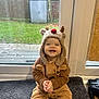 Elijah joined the competition — help win amazing prizes! toddler, child, smiling, reindeer_costume, hat, indoors, carpet, glass_door, window, greenery, garden, shed, floor, clothing, cute, happy, sitting, hands, face, portrait