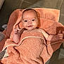 baby, towel, smiling, face, child, skin, hand, floor, tile, indoor, happy, portrait, infant, blanket, cute, young, person, wrapped, expression, warm