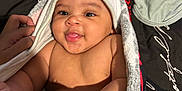 Jeremiah joined the competition — help win amazing prizes! baby, child, towel, hood, smile, face, hand, blanket, black, white, red, pattern, cute, infant, skin, eyes, person, happy, cozy, indoor