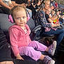 Adalynn is registered to the contest to win money with this photo: blue_eyes, casual_clothing, child, crowd, curly_hair, event, family, focused, headphones, indoor, man, people, pink_clothing, purple_pants, seated, sneakers, spectators, stadium_seating, toddler, woman