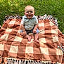 Easton joined the competition — help win amazing prizes! baby, child, blanket, checkered, grass, outdoor, smile, happy, sitting, shirt, shorts, feet, nature, sunlight, greenery, playtime, cute, infant, casual, daylight