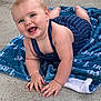 Easton joined the competition — help win amazing prizes! baby, child, smiling, crawling, blue_outfit, blanket, concrete_floor, happy, cute, infant, hands, face, skin, eyes, head, outdoor, clothing, person, portrait, baby_pose