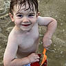 toddler, child, smiling, wet_hair, sand, shovel, bucket, water, play, outdoor, bare_chested, summer, happy, fun, person, closeup, cute, recreation, daylight, skin