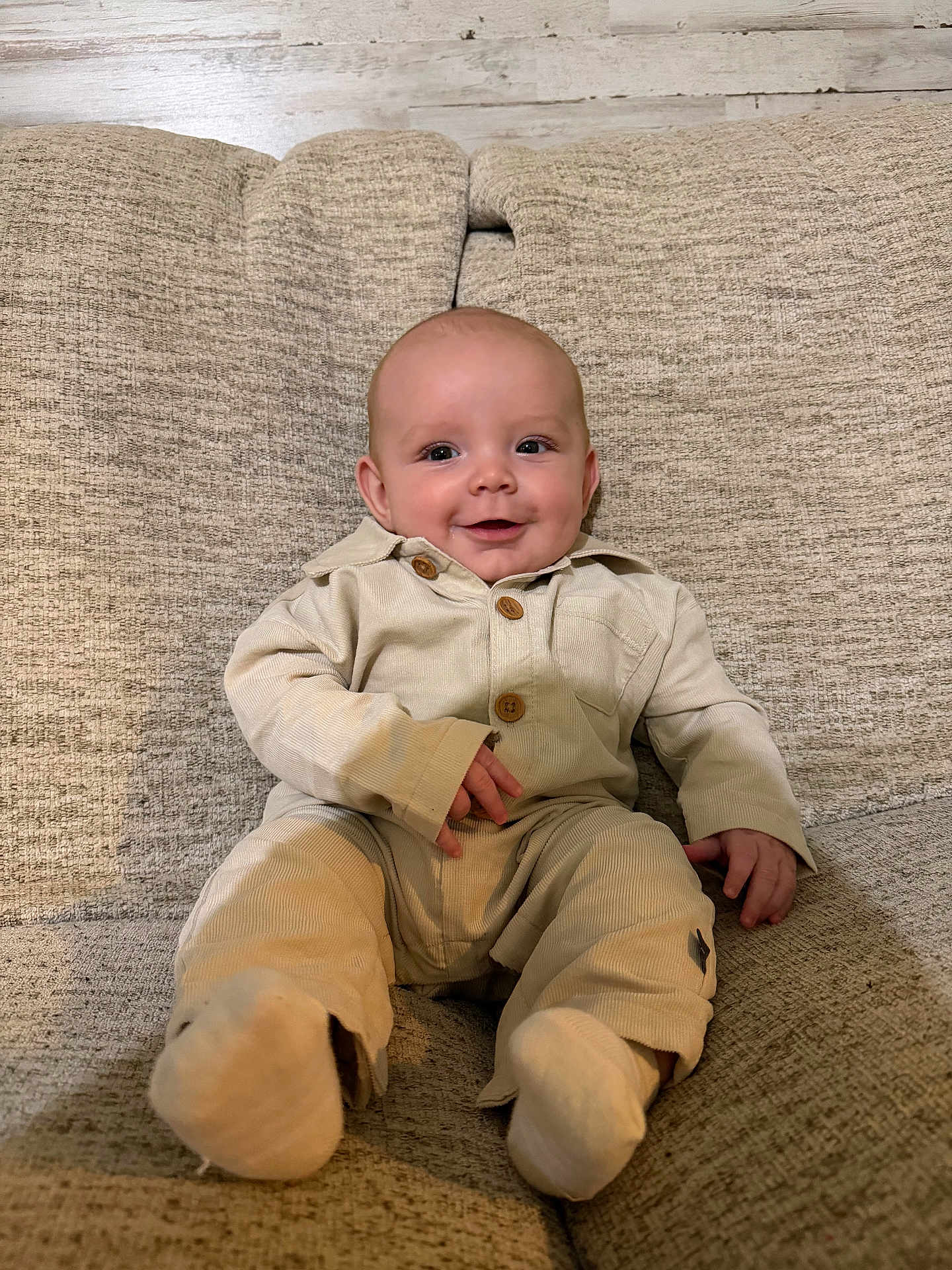 Oliver joined the competition — help win amazing prizes! baby, infant, smiling, couch, beige_clothing, sitting, cute, indoor, portrait, child, happy, cozy, face, baby_clothes, wood_floor, texture, furniture, young_child, buttoned_shirt, sock