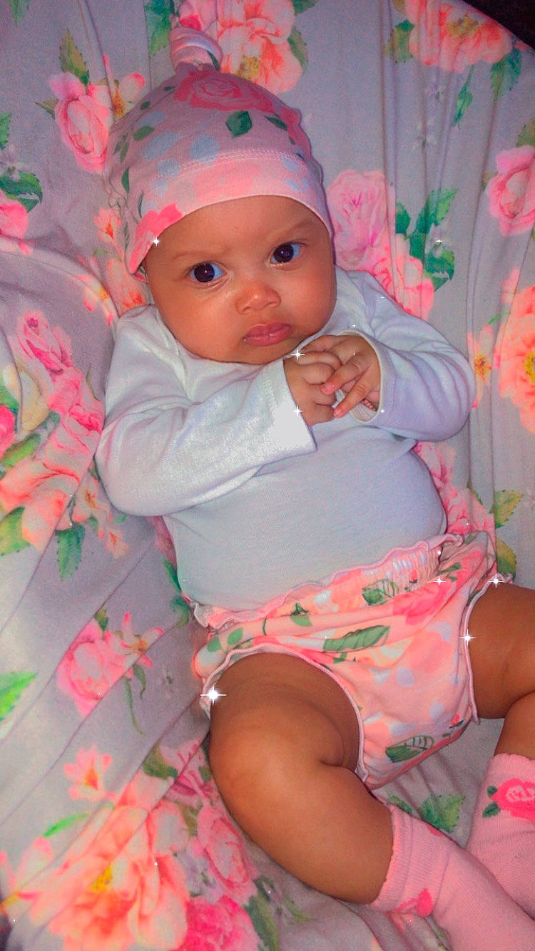 Ava joined the competition — help win amazing prizes! baby, baby_toddler_clothing, cap, cheek, child, eye, face, facial_expression, head, headgear, headwear, human_body, lap, lip, mouth, organ, person, pink, red, skin