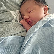 Sofia joined the competition — help win amazing prizes! newborn, baby, sleeping, blanket, blue_blanket, person, grey_shirt, closeup, sleep, infant, face, skin, hand, resting, cozy, soft_texture, indoors, tender_moment, portrait, child