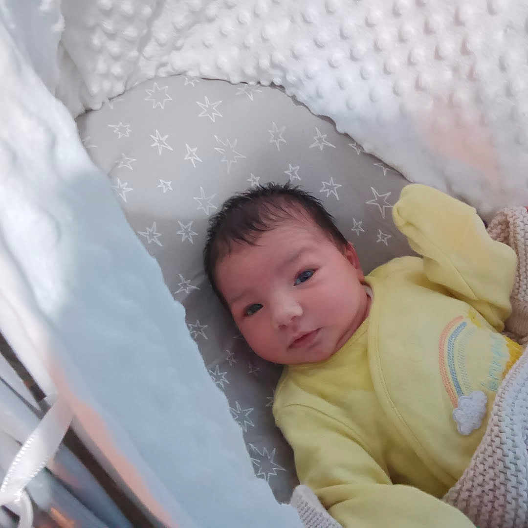 Sofia joined the competition — help win amazing prizes! baby, blanket, closeup, comfort, cozy, cushion, cute, face, head, indoors, infant, newborn, person, rainbow_design, resting, sleepwear, soft_texture, star_pattern, yellow_clothing, young_child