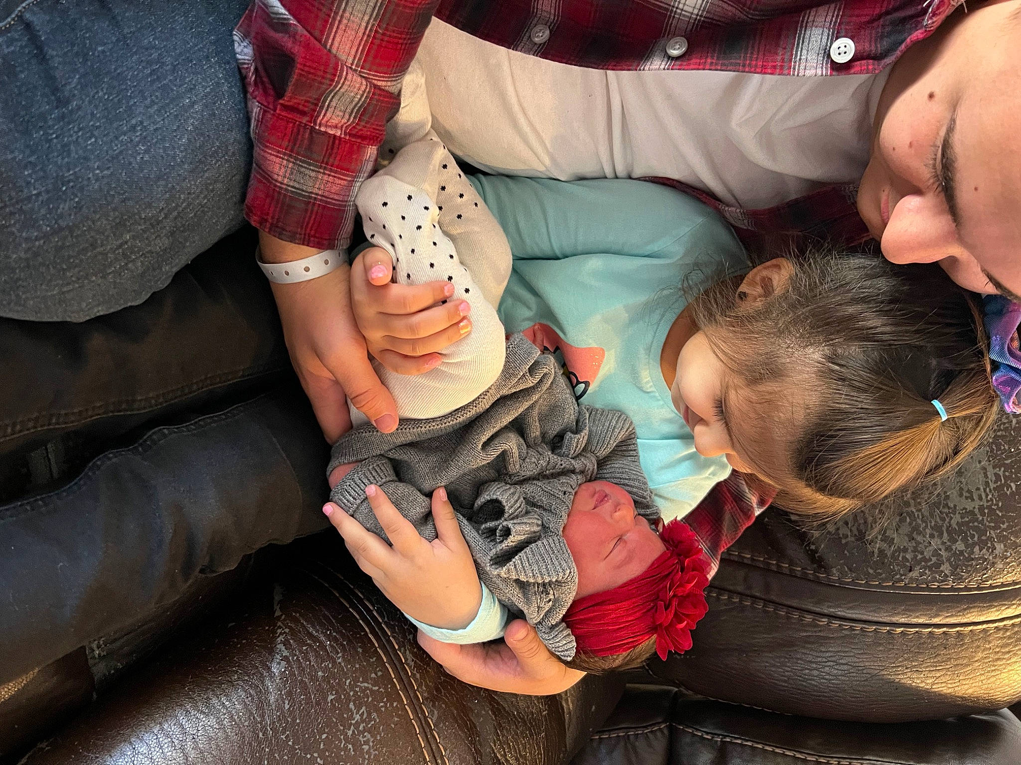 Emberly is registered to the contest to win money with this photo: baby, child, comfort, elbow, event, foot, fun, gesture, happy, headwear, human_leg, knee, lap, mouth, nail, person, sitting, sock, thigh, thumb