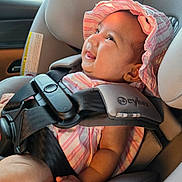 Krishni joined the competition — help win amazing prizes! baby, baby_care, car_interior, car_seat, child, closeup, cute, happy, headwear, indoors, infant, person, pink_hat, portrait, safety_harness, seat, seatbelt, smiling, striped_clothing, sunlight