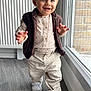 toddler, child, smiling, walking, indoor, vest, shirt, pants, shoes, window, floor, radiator, light, happy, person, clothing, young_child, cute, portrait, home