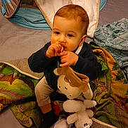 Charli participe au concours pour gagner de l'argent avec cette photo : baby, child, stuffed_animal, blanket, toy, indoor, cute, sitting, thumb_sucking, play_tent, cozy, soft_toy, infant, comfort, bedroom, fabric, childhood, warm, young_child, person