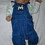 baby, infant, denim_overalls, zebra_patch, minnie_mouse_slippers, footwear, blanket, pink_blanket, clothing, cute, lying_down, raised_hand, indoor, newborn, soft_texture, child, person, sleepwear, baby_fashion, adorable