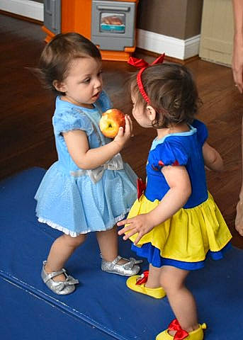 Elle is registered to the contest to win money with this photo: cabinetry, chair, child, costume, electric_blue, event, floor, flooring, fun, happy, leisure, party, person, play, room, sandal, snapshot, standing, toddler, toy