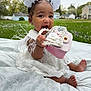 Autumn is registered to the contest to win money with this photo: baby, child, girl, white_dress, lace, outdoor, grass, purse, pearls, flowers, hair_accessories, playful, smiling, sitting, blanket, cute, accessory, foot, hand, portrait