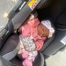 baby, car_seat, child, cozy, cute, fabric, floral_pattern, headband, infant, newborn, outside, pacifier, peaceful, pink_clothing, resting, seat_belt, sleeping, soft_light, sunlight, toddler