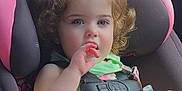 Everleigh is registered to the contest to win money with this photo: baby, baby_bottle, blue_eyes, car_interior, car_seat, child, curly_hair, cute, green_top, hand_in_mouth, infant, pink_car_seat, portrait, safety_harness, seatbelt, sitting, toddler, travel, vehicle, young_child