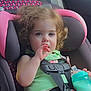 baby, baby_bottle, blue_eyes, car_interior, car_seat, child, curly_hair, cute, green_top, hand_in_mouth, infant, pink_car_seat, portrait, safety_harness, seatbelt, sitting, toddler, travel, vehicle, young_child