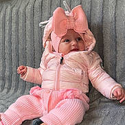 Zinaya a rejoint le concours — aidez-le/la à gagner de superbes lots ! baby, pink_clothing, knitwear, bow_hat, jacket, slippers, minnie_mouse, blanket, indoor, child, cute, warm_clothes, smiling, seated, soft_texture, cozy, portrait, infant, happy, apparel