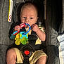 Jaxon joined the competition — help win amazing prizes! baby, car_seat, teething_toy, infant, child, clothing, seatbelt, cute, indoor, plastic_toy, hand, foot, head, eyes, mouth, pacifier, fabric, sitting, safety, young